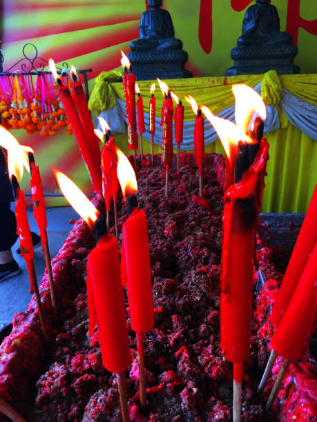 istock burning red chinese candle in temple 1746130113