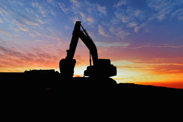 istock Crawler excavators silhouette are digging the soil in the construction site. 1746148165