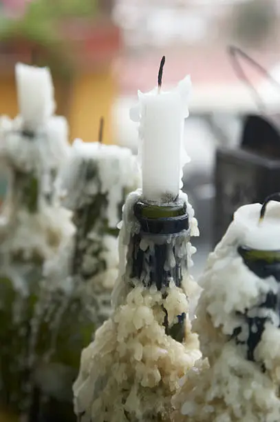 Candlewax encrusted wine bottles