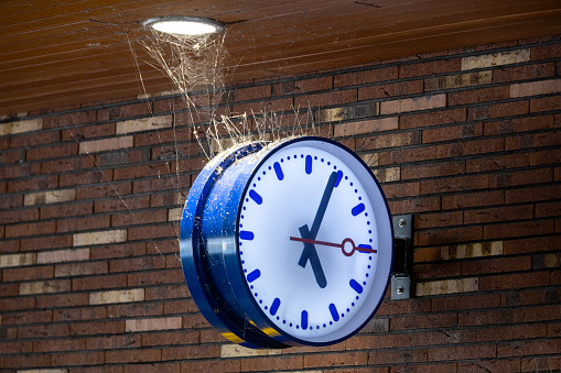 Utrecht, the Netherlands. 24 September 2023. public transport clock where time stands still. 5 past 5. Spider web and dust on the clock.