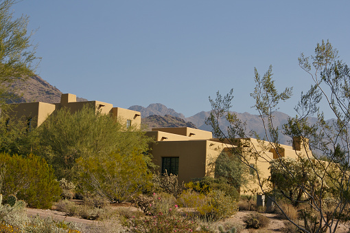 Secluded large ranch style mansion in desert outside of Scottsdale, AZ covered with mesquite trees and sagebrush plants to keep it hidden