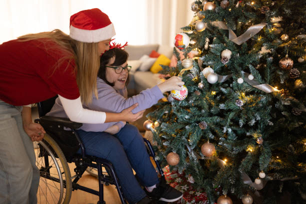 istock People with Down syndrome decorating a Christmas tree with their friends 1746158517