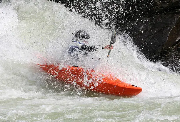 Boater scooting down a wall of whitewater.