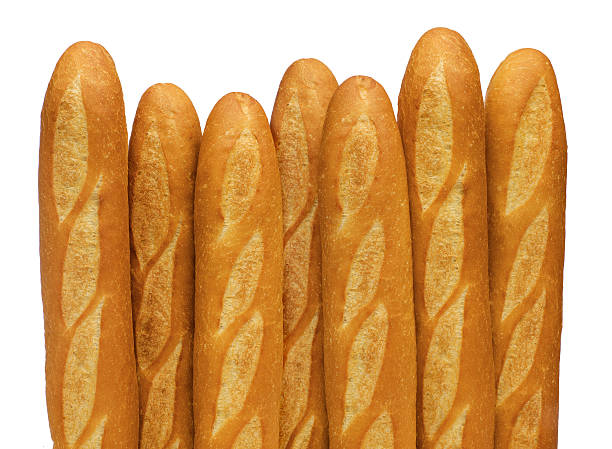 French baguettes stand vertically against a white backdrop stock photo