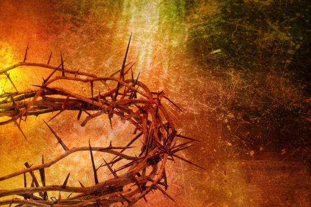 Thorn wreath against blue background in sunlight. Symbol of death and resurrection of Jesus Christ. Close up.