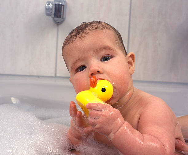 istock baby in bath with rubber duck 174616052