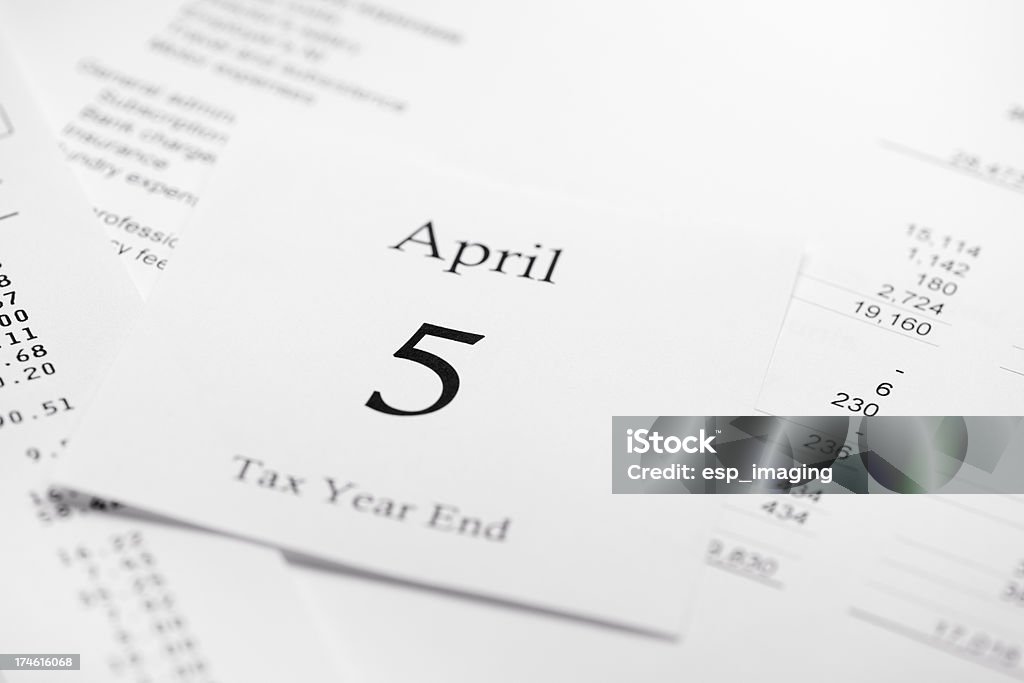 April 5th Tax Accounting Year End Tax Accounting Year End - April 5th calendar page on background of acounts sheets and financial tables.See also: Tax Stock Photo