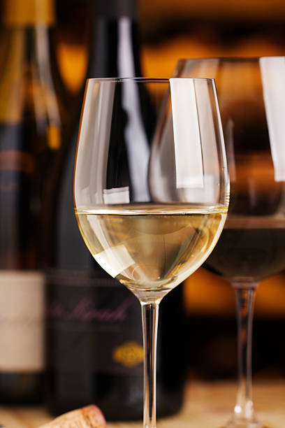 istock White Wine in Winetasting Glass with Cellar Bottles for Tasting 174616245