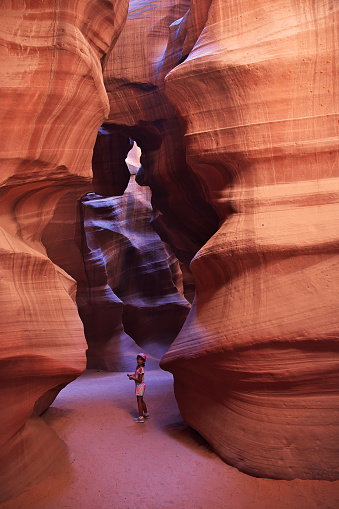 Young woman in Antelope Canyon in Arizona. Tourist in Antelope Canyon. Adventure and hiking concept.