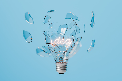 Light bulb exploding with the word IDEA on the incandescent filament on a blue isolated background. 3d rendering
