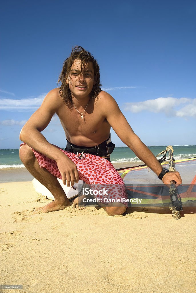 windsurfer a young windsurfer posing with his windsurfing gear. 20-29 Years Stock Photo