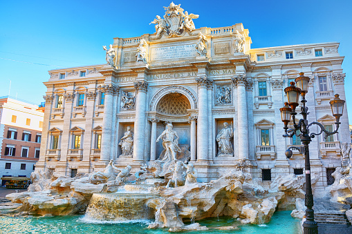 Couple contemplating the Trevi fountain in Rome, Italy\nPeople travel enjoying capital cities of Europe concept