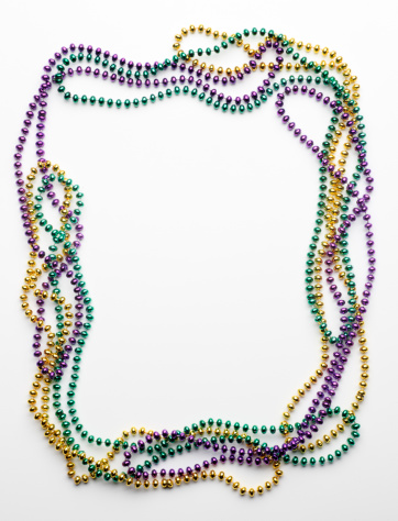 Mardi Gras beads on white background