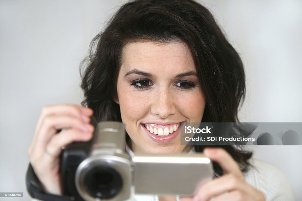 Woman Having Fun Videoing A girl trying out her new video camera.See more from this series: Adult Stock Photo