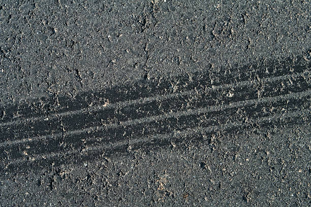 istock Tire track on weathered asphalt 174618438