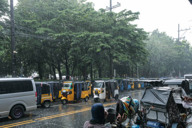 rainy season squall A street corner in Manila hit by a sudden squall philippines tricycle stock pictures, royalty-free photos & images