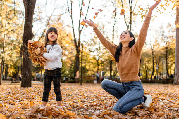 istock Playing with autumn leaves on a sunny day in park 1746184904