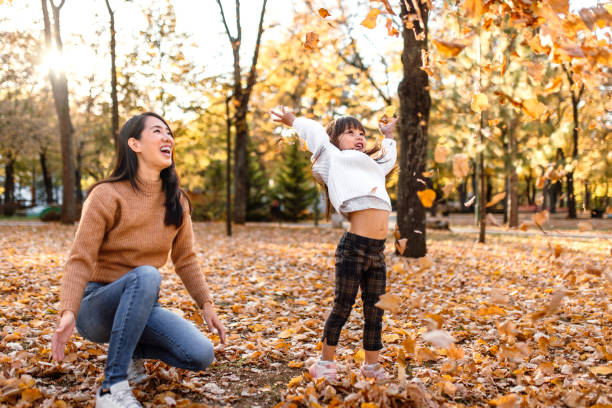 istock Playing with autumn leaves on a sunny day in park 1746184906