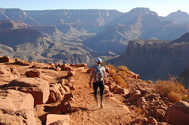 Woman hiking in Canyon A female hiking on the South Kaibab trail at the Grand Canyon. south kaibab trail stock pictures, royalty-free photos & images