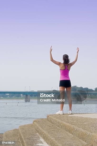 Arms Raised At Riverside Stock Photo - Download Image Now - 20-24 Years, Active Lifestyle, Adult