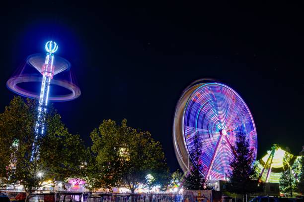 istock people on the side walk near a ferris wheel at night 1746192423