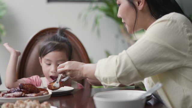 Asian family eat breakfast together at home.