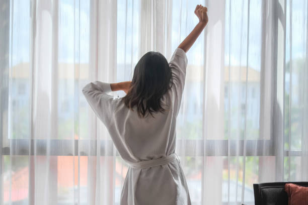istock Happy Single Traveller Waking Up in Hotel Room 1746193589