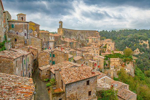 In the quiet medieval village of Sorano, Tuscany, you'll step into a beautifully preserved piece of history. With no people in sight, this charming old town offers a cityscape frozen in time. Its ancient architecture, narrow streets, and old buildings tell tales of Italian culture and traditions. The town's famous bell tower and church are iconic landmarks, while the quaint rooftops and winding alleys create an idyllic setting. Sorano, in the Grosseto Province, is a small town where the past comes to life, making it a must-visit for history and architecture enthusiasts.