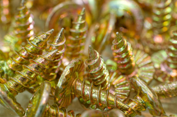 Random pile of galvanized screws, abstract industrial background