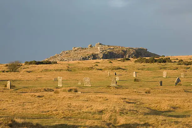 "the Hurlers stone circles (thought to be 3,500 years old) on Bodmin Moor with the Cheesewring quarry, part of Cornwall's post industrial landscape"