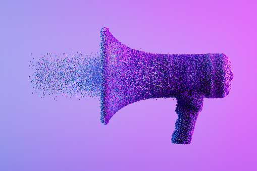 Megaphone exploding with particles on neon background. Digitally generated image.