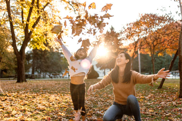 istock Playing with autumn leaves on a sunny day in park 1746202876