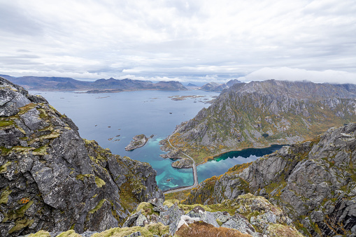 Lofoten landscape with road and bridge connecting the islands over the sea. Henningsvaer village Austvagoya island, Norway, overcast weather.