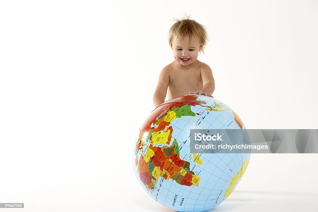 Toddler Pushing Inflatable Globe Young Girl Pushing Inflatable Globe Against White Background 12-17 Months Stock Photo