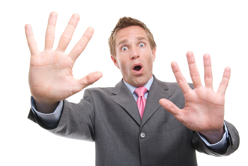 Businessman puts both hands up with a panicked surprised expression of Whoa!