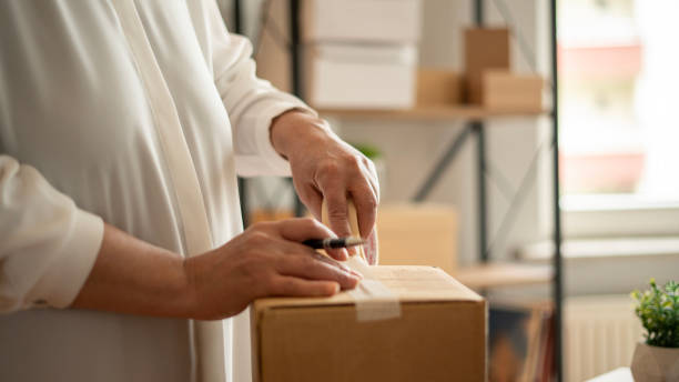 istock Small business woman taping order box 1746216488