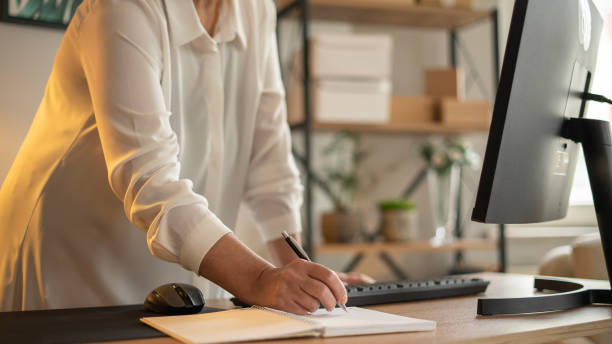 istock Small business owner woman taking notes in notebook 1746216491