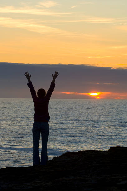 istock Young woman celebrating the sunset 174621688