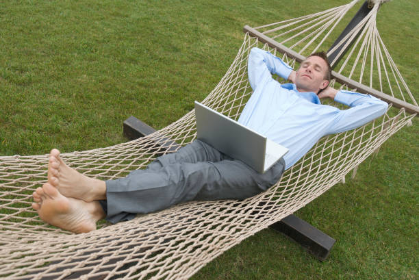 istock Relaxed Businessman Lying Back for Siesta in Hammock 174621704