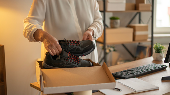 Small business adult woman prepares shoe order