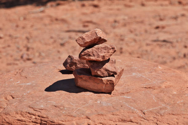 Cairn Of Six Rocks Stands To Mark The Way of trail over smooth rock
