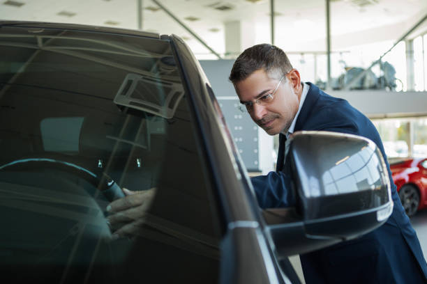 istock Man is looking at the car in auto salon 1746223578