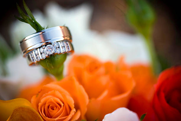 A pair of wedding rings on a rose stem