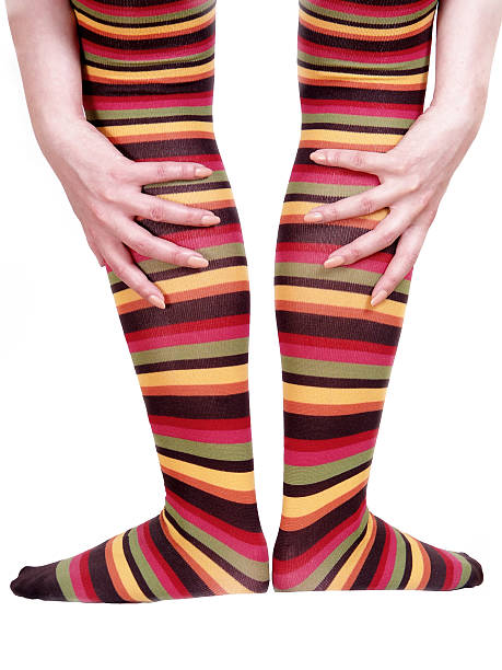 istock woman legs in striped stocking with hands (colors) 174622489