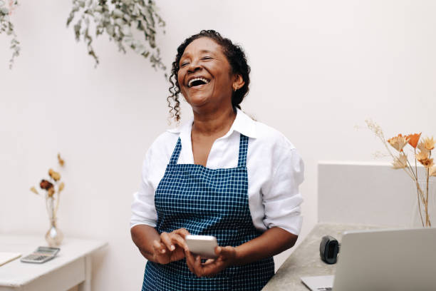 istock Successful small business owner using a smartphone to run her store 1746233982