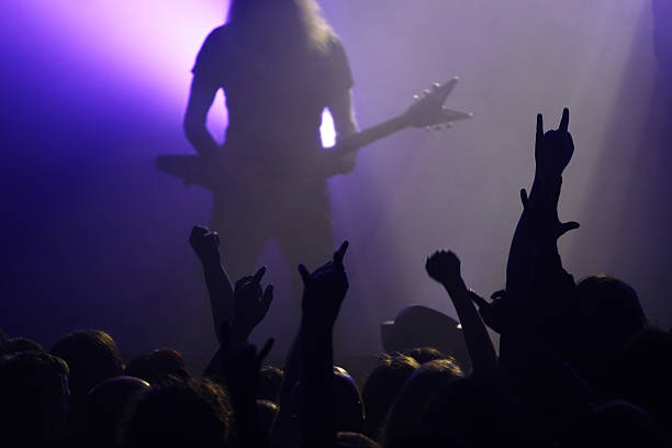 Guitarist silhouette on stage Silhouette of a gruitarist on a big stage hair band stock pictures, royalty-free photos & images