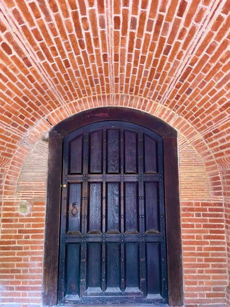 istock Wooden door set in arched brick frame 1746237866