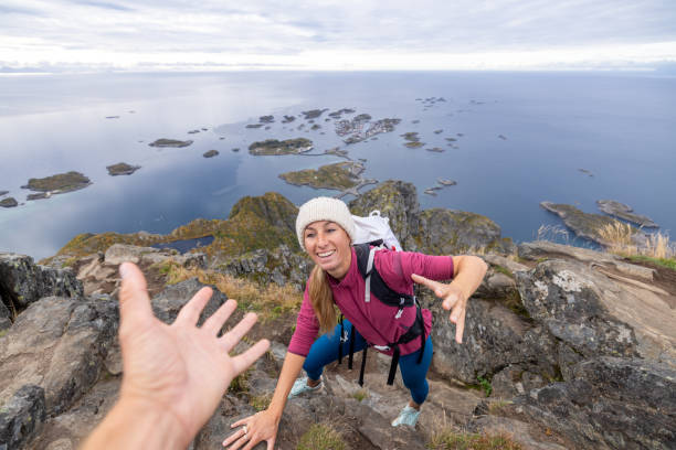 istock Hiker helping teammate to reach mountain top, summit 1746238943