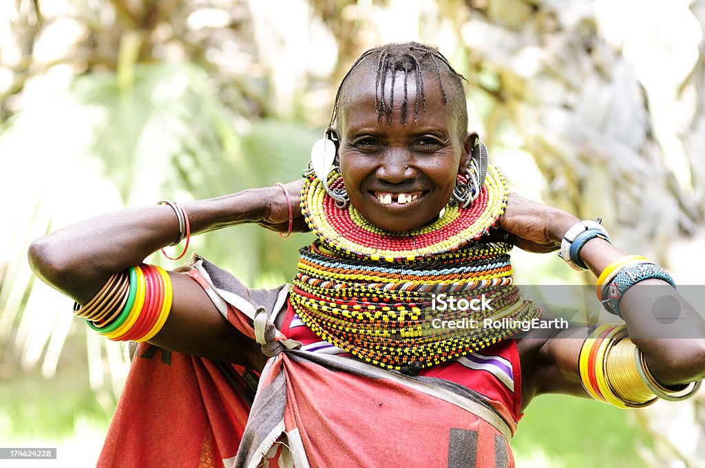 Turcana Woman "A Turcana tribeswoman in traditional beadwork. Lake Turcana, Kenya.The Turkana are Kenya's third-largest tribe and the second largest group of nomadic pastoralists (after Maasai). The majority live in Turkana District of Rift Valley in the arid northwest of Kenya. Most of Turkana are cattle herders, some engage in small-scale agriculture and fishing on Lake Turkana. They speak Turkana which is similar to the Maasai language and is considered to be of Nilotic in origin.Traditional dress and ornaments are of vital importance, much emphasis being placed on adornment of both women and young Morani (warrior). Beads and jewelry indicate a woman's wealth and marital status. The traditional hairstyle for a woman is a braided Mohawk." Bead Stock Photo