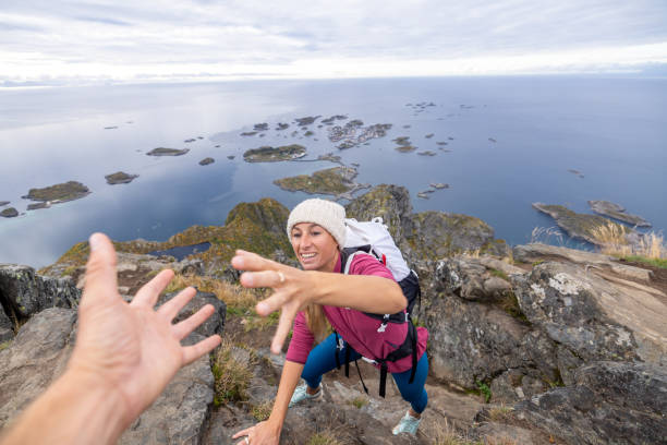 istock Hiker helping teammate to reach mountain top, summit 1746243638